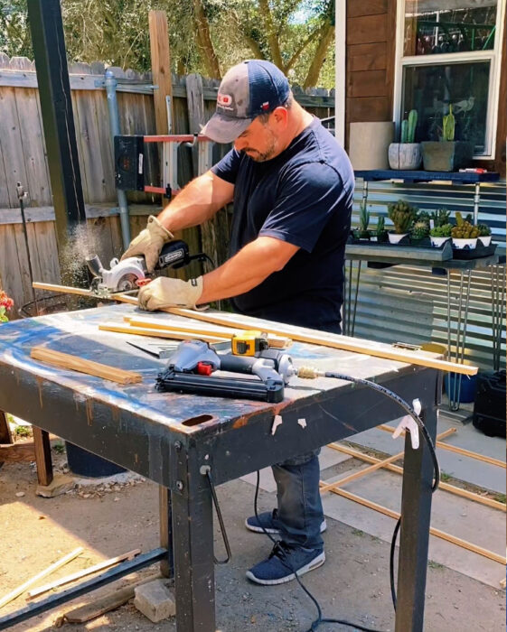 man cutting wood